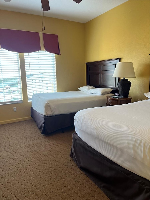 carpeted bedroom with baseboards and ceiling fan