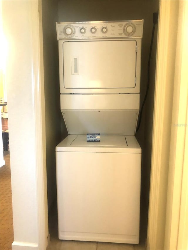 laundry room with stacked washer and dryer