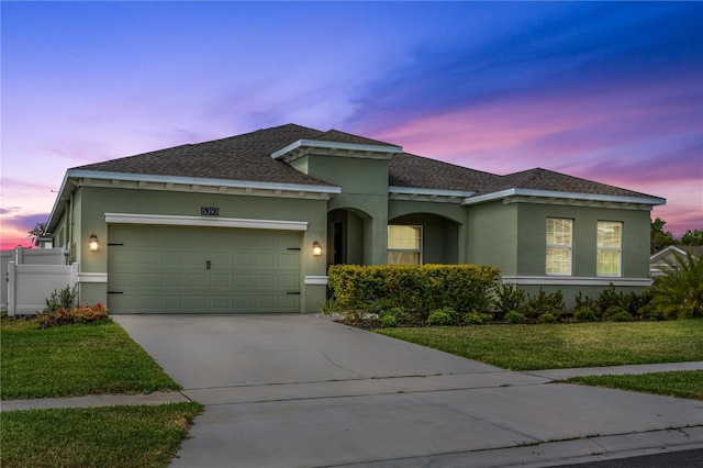 5393 Red Coral Cir, Mount Dora, FL 32757 - view of front of home with stucco siding, driveway, a garage, and a shingled roof