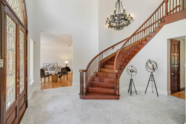 2828 Marquesas Ct, Windermere, FL 34786 - entrance foyer featuring a towering ceiling, stairs, a chandelier, and baseboards