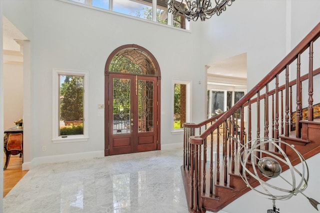 2828 Marquesas Ct, Windermere, FL 34786 - entrance foyer with healthy amount of natural light, a chandelier, a towering ceiling, and stairway