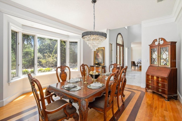 2828 Marquesas Ct, Windermere, FL 34786 - dining area featuring a chandelier, light wood-style floors, ornamental molding, and baseboards