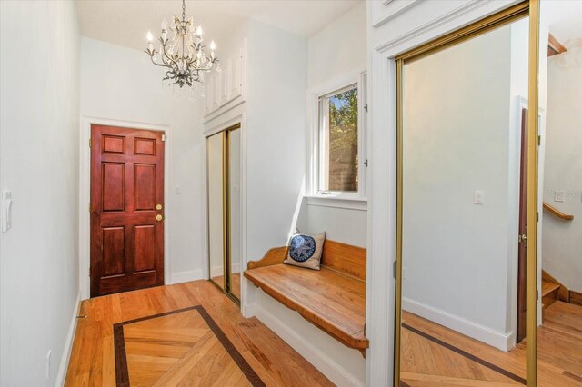 2828 Marquesas Ct, Windermere, FL 34786 - entrance foyer with light wood-style flooring, a chandelier, baseboards, and stairway