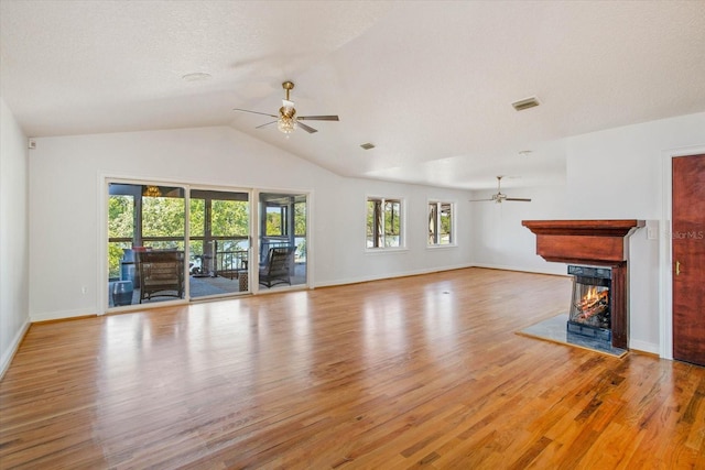 2828 Marquesas Ct, Windermere, FL 34786 - unfurnished living room featuring ceiling fan, wood finished floors, a multi sided fireplace, vaulted ceiling, and baseboards