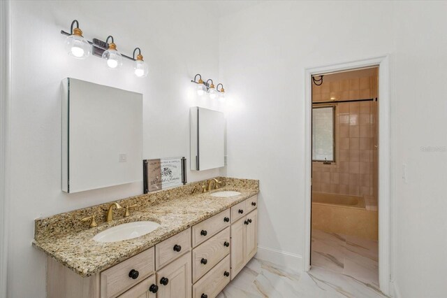 2828 Marquesas Ct, Windermere, FL 34786 - full bath featuring marble look tiles, double vanity, baseboards, and bathing tub / shower combination