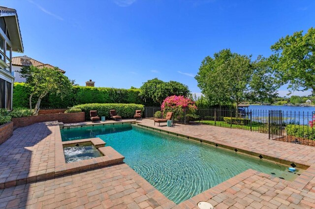 2828 Marquesas Ct, Windermere, FL 34786 - view of pool featuring a patio area, a pool with connected hot tub, fence, and a water view