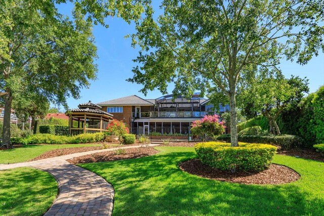 2828 Marquesas Ct, Windermere, FL 34786 - rear view of house featuring a gazebo, a yard, and a balcony