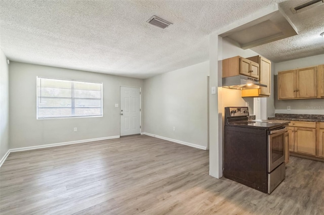 kitchen with visible vents, dark countertops, a textured ceiling, under cabinet range hood, and stainless steel electric stove