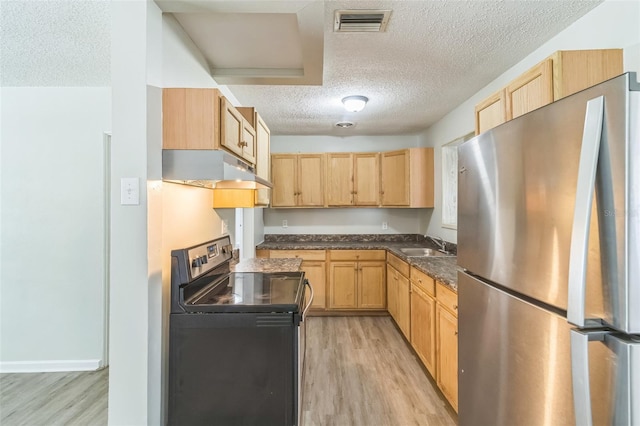 kitchen with range with electric stovetop, freestanding refrigerator, under cabinet range hood, and light brown cabinetry