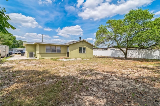 rear view of property with fence and cooling unit