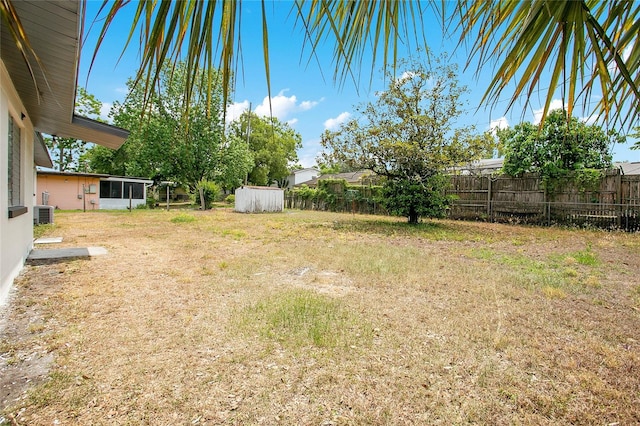 view of yard featuring a fenced backyard and central air condition unit