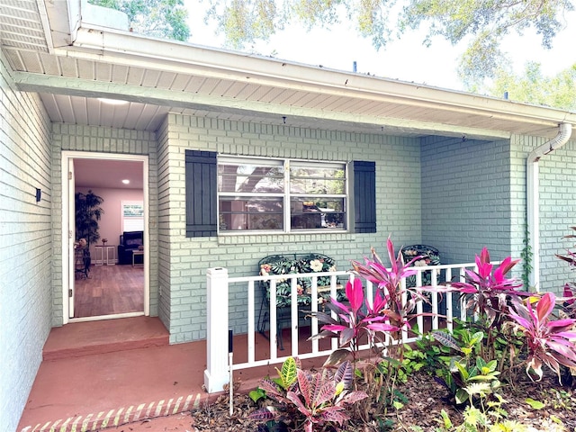 9490 SW 85th Ave Unit E, Ocala, FL 34481 - entrance to property featuring brick siding and covered porch