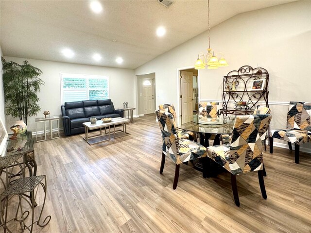 9490 SW 85th Ave Unit E, Ocala, FL 34481 - dining space featuring vaulted ceiling, light wood-type flooring, recessed lighting, a chandelier, and baseboards