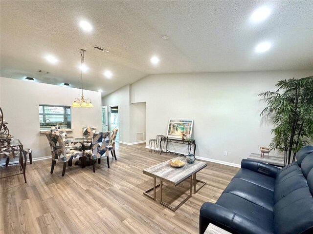 9490 SW 85th Ave Unit E, Ocala, FL 34481 - living area featuring recessed lighting, light wood-style flooring, a textured ceiling, vaulted ceiling, and baseboards
