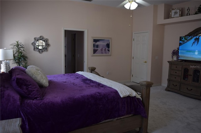 bedroom with ceiling fan and light carpet