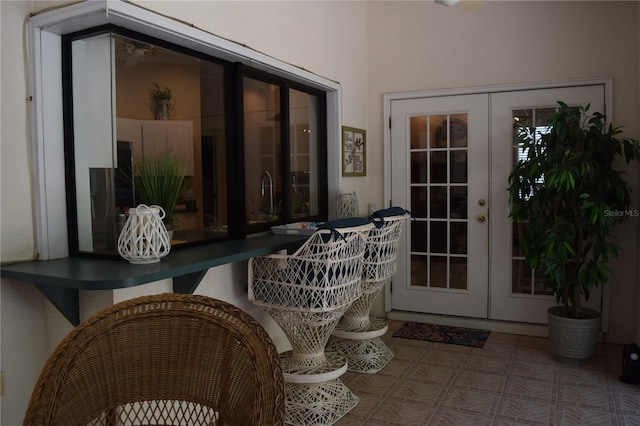 view of exterior entry with french doors and a patio
