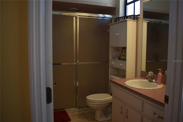 bathroom featuring vanity, a stall shower, tile patterned floors, and toilet