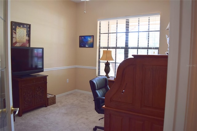 carpeted office space featuring baseboards