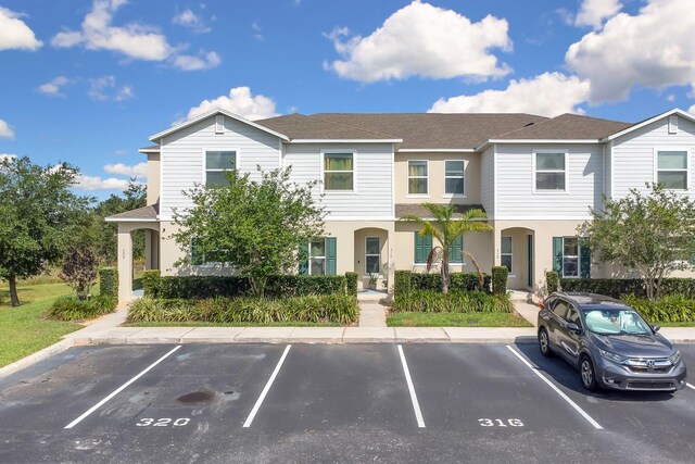 320 Primrose Dr, Davenport, FL 33837 - view of front facade with uncovered parking and roof with shingles
