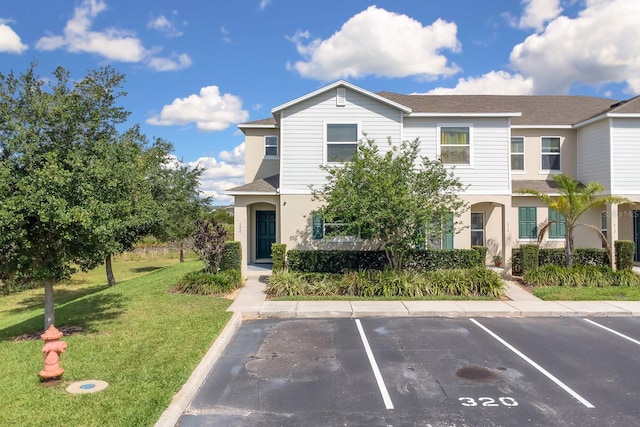 320 Primrose Dr, Davenport, FL 33837 - multi unit property featuring uncovered parking, a front yard, stucco siding, and roof with shingles