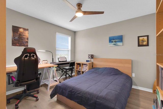 320 Primrose Dr, Davenport, FL 33837 - bedroom with a desk, baseboards, ceiling fan, and wood finished floors
