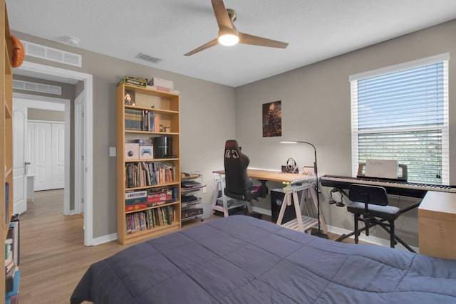 320 Primrose Dr, Davenport, FL 33837 - bedroom with wood finished floors, baseboards, a desk, and a ceiling fan