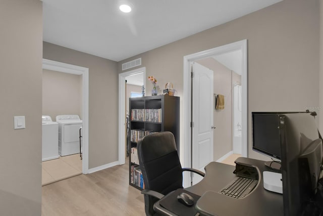 320 Primrose Dr, Davenport, FL 33837 - home office featuring washing machine and dryer, light wood-type flooring, and baseboards