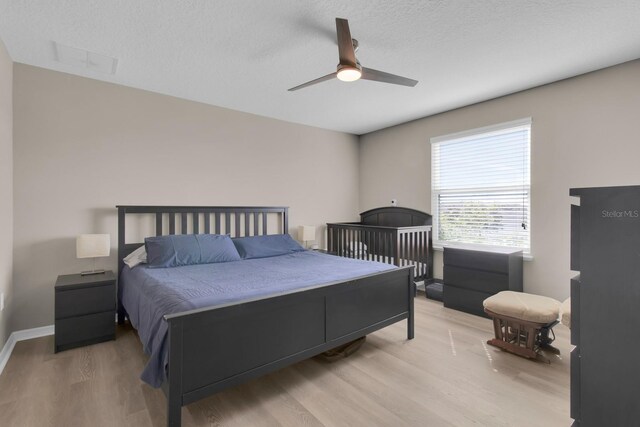 320 Primrose Dr, Davenport, FL 33837 - bedroom featuring light wood-type flooring, a textured ceiling, and ceiling fan