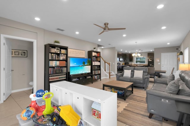 320 Primrose Dr, Davenport, FL 33837 - living area featuring a ceiling fan, light tile patterned flooring, stairway, recessed lighting, and a chandelier
