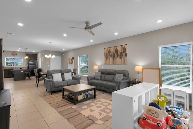320 Primrose Dr, Davenport, FL 33837 - living room with a chandelier, light tile patterned floors, a ceiling fan, recessed lighting, and healthy amount of natural light