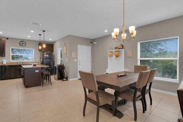 320 Primrose Dr, Davenport, FL 33837 - dining space featuring a chandelier, recessed lighting, light tile patterned floors, and baseboards