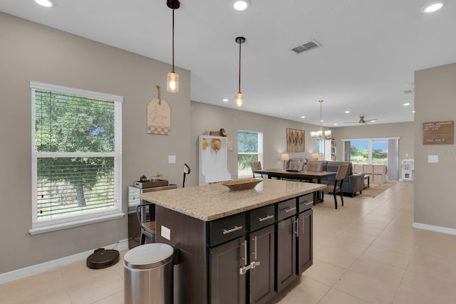 320 Primrose Dr, Davenport, FL 33837 - kitchen featuring baseboards, a center island, hanging light fixtures, recessed lighting, and light tile patterned floors