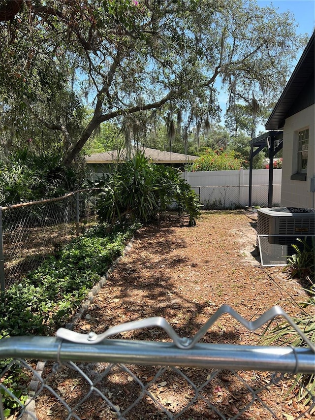 261 Deleon Rd, Debary, FL 32713 - view of yard featuring cooling unit and a fenced backyard