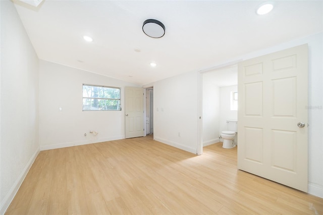 unfurnished bedroom featuring recessed lighting, light wood-style flooring, lofted ceiling, and baseboards