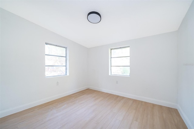 spare room with light wood-style floors and baseboards