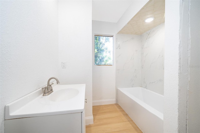 full bath with vanity, a tub, baseboards, walk in shower, and wood finished floors