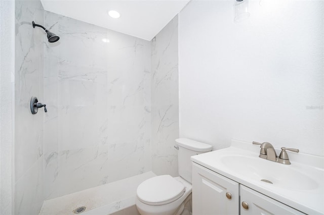 bathroom with vanity, toilet, and a shower stall