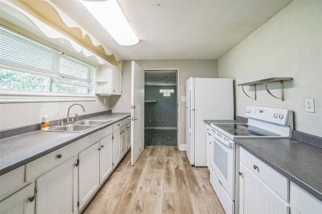 kitchen featuring white appliances, light wood-style flooring, open shelves, white cabinets, and a sink