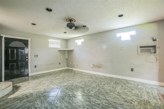 washroom featuring a wall unit AC, marble finish floor, and baseboards