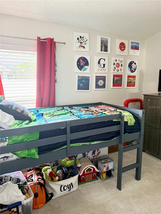 bedroom with carpet flooring and a textured ceiling
