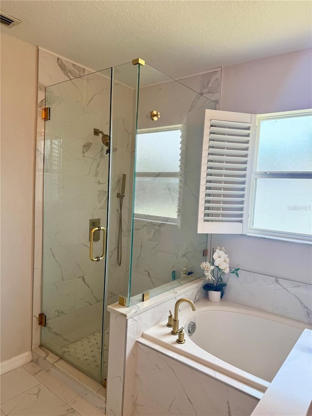 bathroom with a textured ceiling, a marble finish shower, marble finish floor, visible vents, and a garden tub