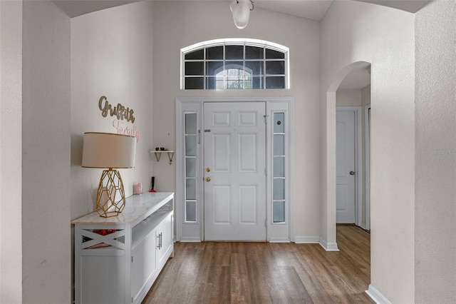 2407 Oakington St, Winter Garden, FL 34787 - entrance foyer featuring arched walkways, wood finished floors, and baseboards