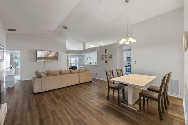 2407 Oakington St, Winter Garden, FL 34787 - dining room featuring arched walkways, dark wood-type flooring, baseboards, and high vaulted ceiling