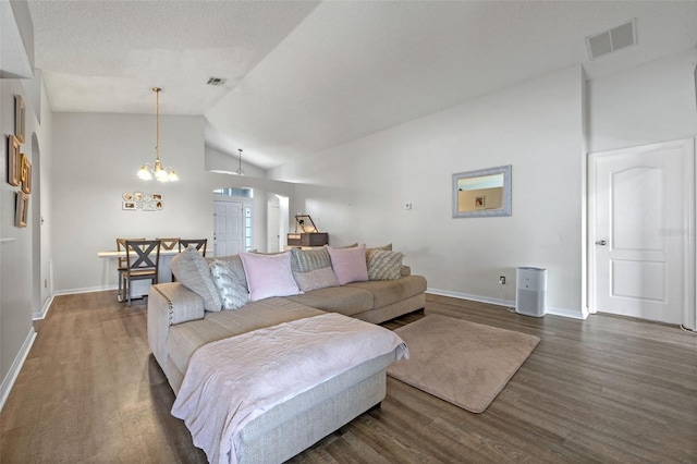 2407 Oakington St, Winter Garden, FL 34787 - living area featuring dark wood finished floors, baseboards, a chandelier, and high vaulted ceiling