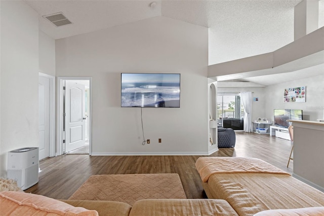 2407 Oakington St, Winter Garden, FL 34787 - living room featuring wood finished floors, high vaulted ceiling, baseboards, and arched walkways