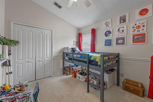 2407 Oakington St, Winter Garden, FL 34787 - carpeted bedroom featuring a textured ceiling, a closet, vaulted ceiling, ceiling fan, and baseboards