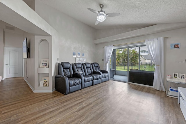 2407 Oakington St, Winter Garden, FL 34787 - living area featuring wood finished floors, a ceiling fan, a textured ceiling, and high vaulted ceiling
