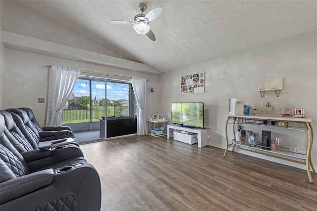 2407 Oakington St, Winter Garden, FL 34787 - living room featuring vaulted ceiling, a ceiling fan, wood finished floors, and a textured ceiling
