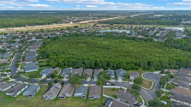 2407 Oakington St, Winter Garden, FL 34787 - aerial view of property's location with nearby suburban area, a nearby body of water, and a heavily wooded area