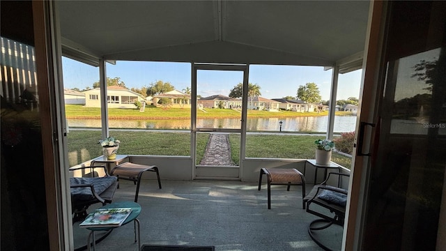 sunroom / solarium with a residential view, a water view, and plenty of natural light